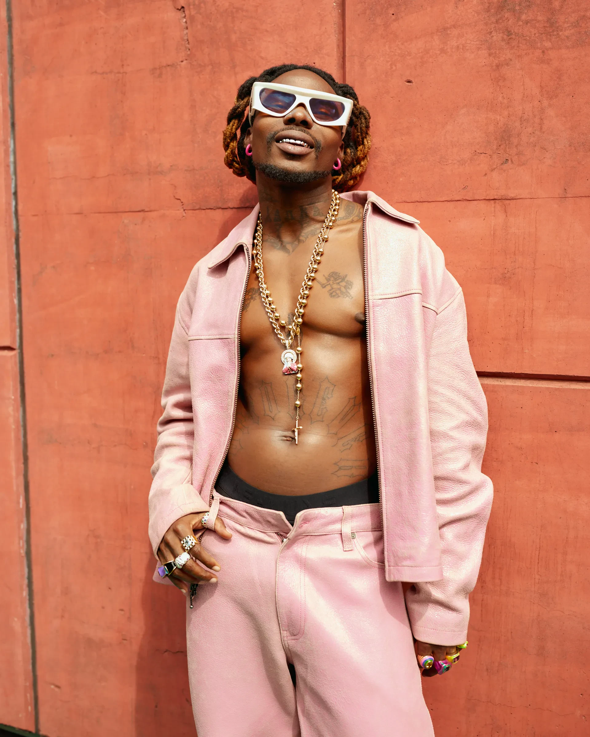 Editorial gallery of Asake styled in neutral winter outfits highlighting sapphire, burgundy, and smoked grays, highlighting steel blue, cranberry, optic white, graphite, and imperial purple.