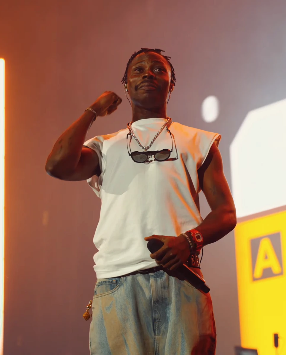 Asake wearing balanced jewel-toned looks with cool neutrals, showcasing steel blue, cranberry, optic white, graphite, and imperial purple from the Neutral Winter palette.