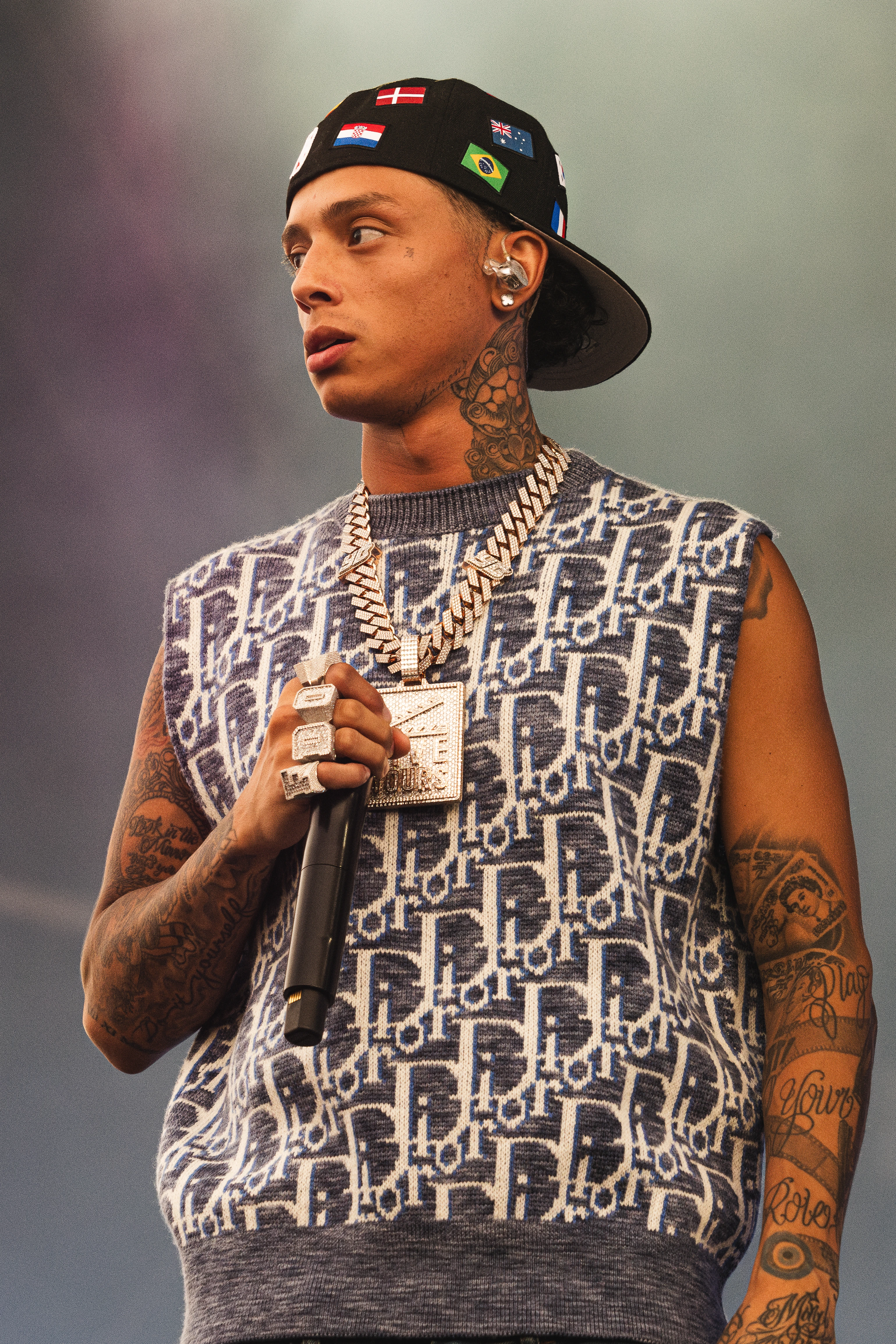 Central Cee wearing luminous spring outfits with juicy warm hues, showcasing papaya orange, sunny marigold, aqua turquoise, creamy ivory, and rose gold from the Warm Spring palette.