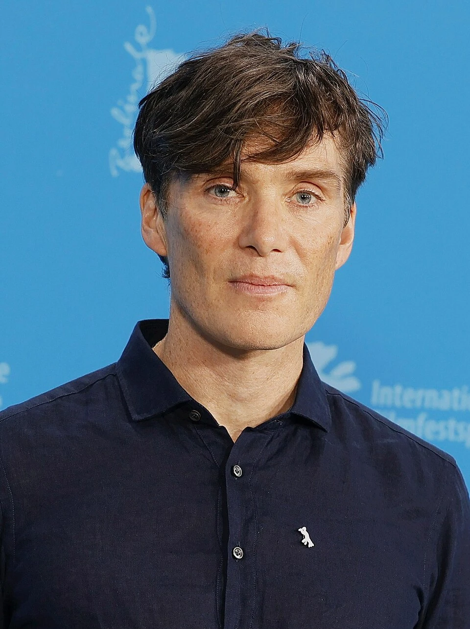 Editorial gallery of Cillian Murphy styled in light summer outfits blending powder blues, lilac, and silvery neutrals, highlighting sky blue, cool blush, opal gray, mint chiffon, and soft navy.