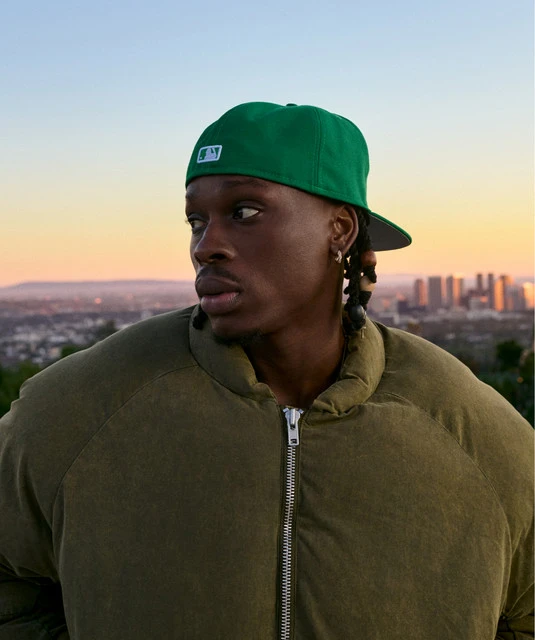 Fireboy DML wearing sun-soaked autumn looks with rich neutrals and texture, showcasing amber, rust, olive, bronze, and cream from the Warm Autumn palette.