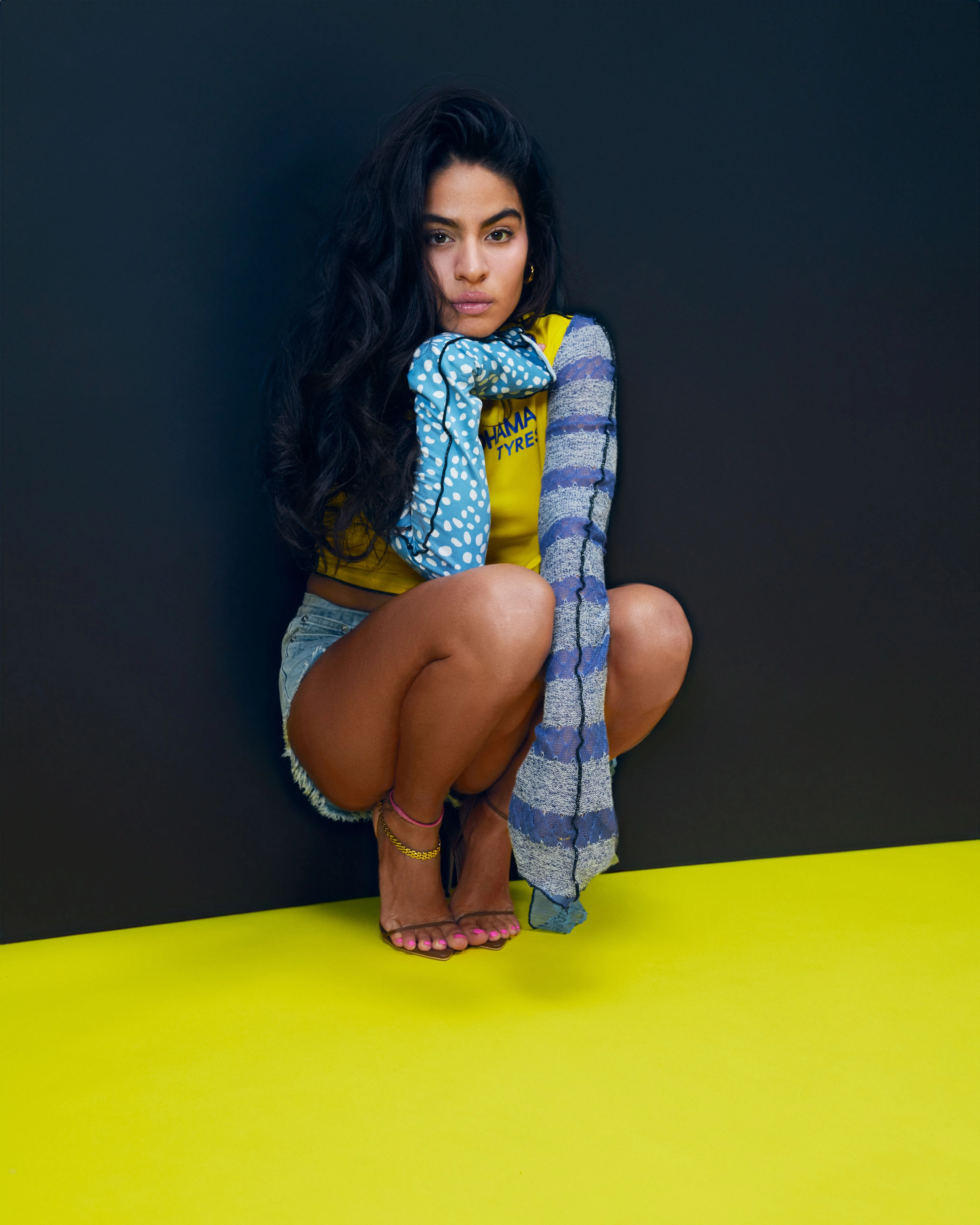 Editorial gallery of Jessie Reyez styled in warm spring looks packed with coral, turquoise, and golden accents, highlighting papaya orange, sunny marigold, aqua turquoise, creamy ivory, and rose gold.