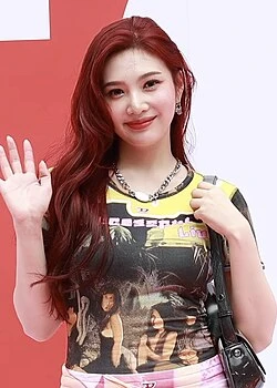 Joy (Red Velvet) wearing jewel-toned statement dressing with crisp contrast and sparkle, showcasing electric cobalt, icy magenta, optic white, chrome silver, and inky black from the Bright Winter palette.