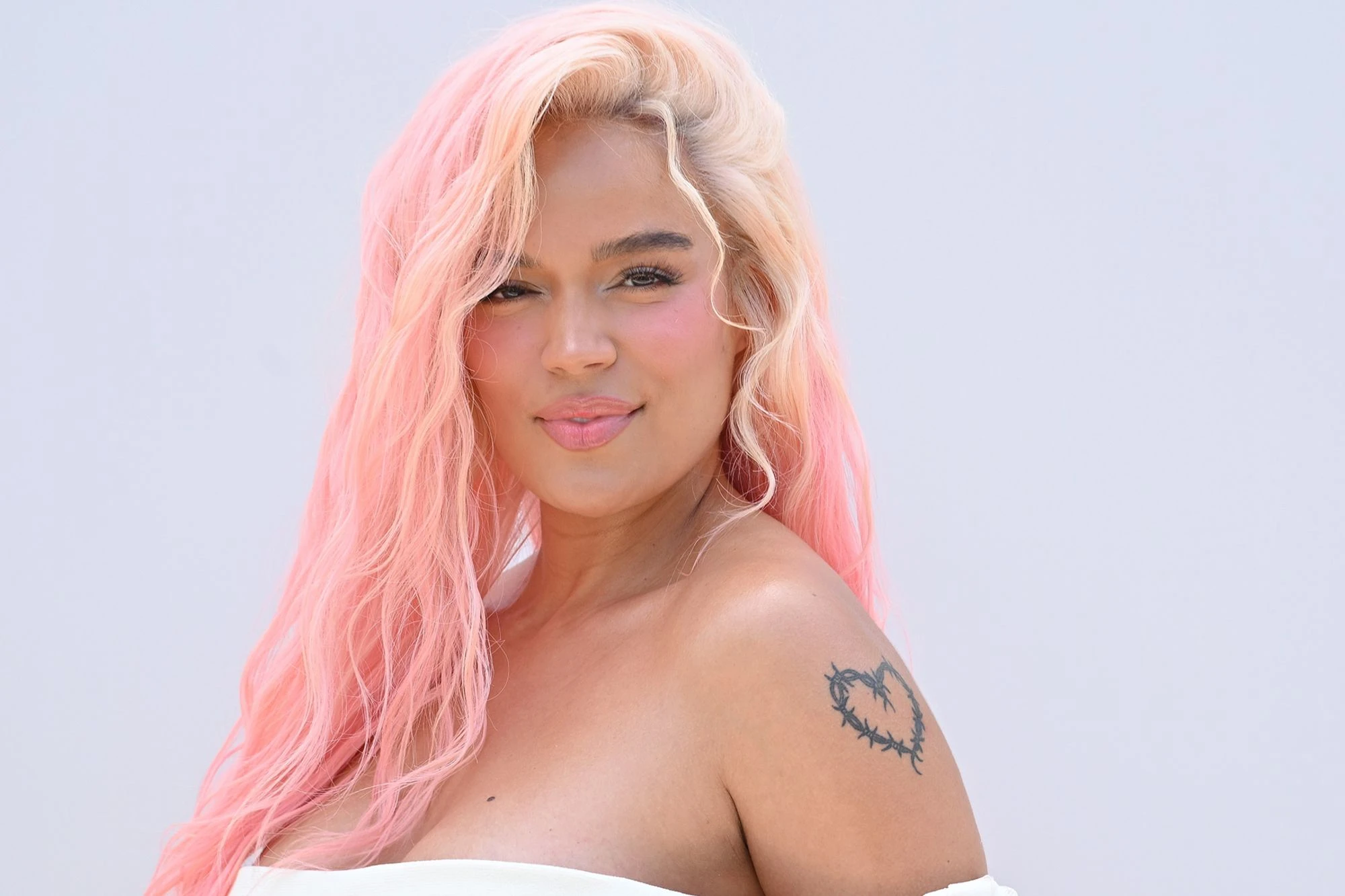 Editorial gallery of Karol G styled in warm spring looks packed with coral, turquoise, and golden accents, highlighting aqua, coral, tangerine, sunny yellow, and seafoam.