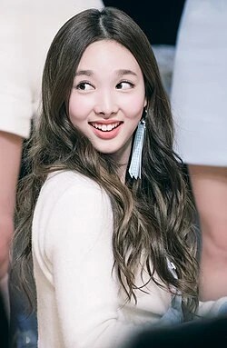 Editorial gallery of Nayeon (TWICE) styled in cool winter outfits featuring sapphire, amethyst, and inky neutrals, highlighting glacier blue, raspberry, graphite, arctic white, and ultra black.