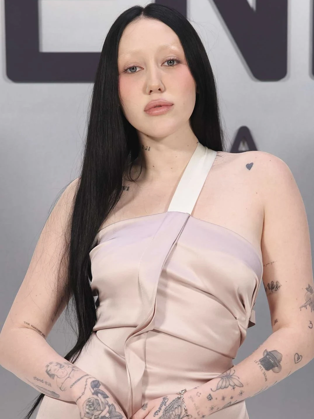 Editorial gallery of Noah Cyrus styled in light summer outfits blending powder blues, lilac, and silvery neutrals, highlighting sky blue, cool blush, opal gray, mint chiffon, and soft navy.