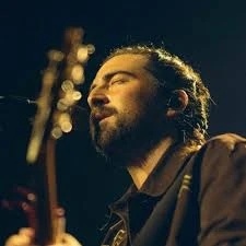 Editorial gallery of Noah Kahan styled in light spring looks full of sherbet pinks, mint greens, and warm ivory, highlighting sherbet peach, sea glass, buttermilk, mint foam, and rose coral.