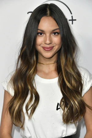 Editorial gallery of Olivia Rodrigo styled in bright winter looks with electric blues, magenta accents, and polished black, highlighting electric violet, crystal white, ink black, cherry red, and midnight navy.