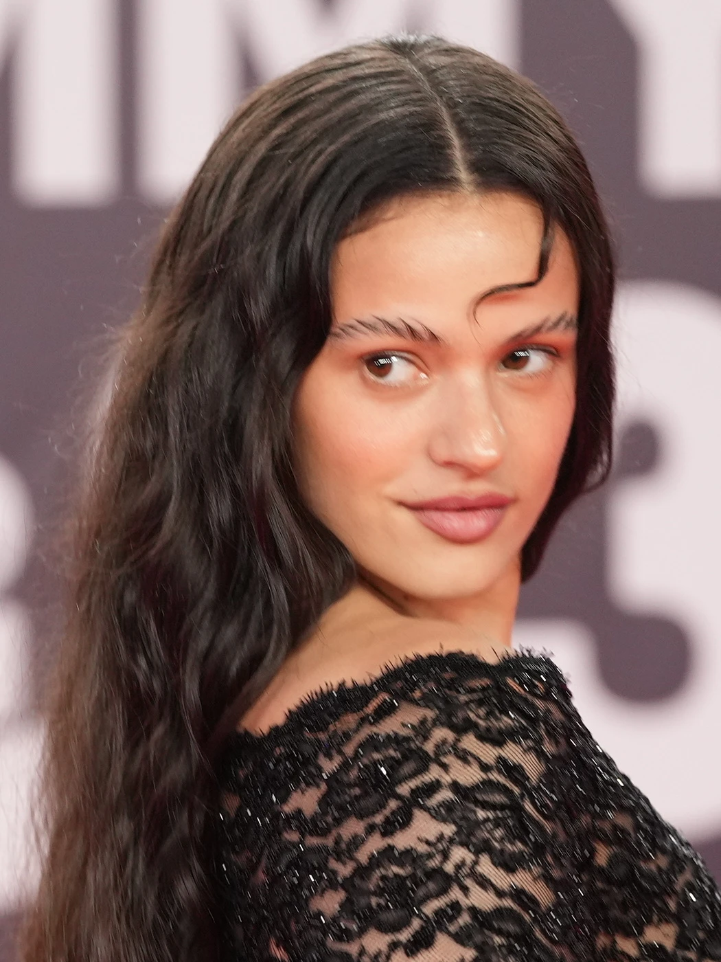 ROSALÍA wearing high-contrast electric brights paired with sharp tailoring, showcasing vermilion, jet black, crystal white, chrome, and electric magenta from the Bold Winter palette.