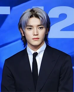 Taeyong (NCT) wearing balanced jewel-toned looks with cool neutrals, showcasing steel blue, cranberry, optic white, graphite, and imperial purple from the Neutral Winter palette.