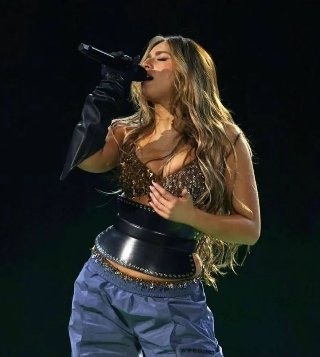 Tate McRae wearing high-voltage winter ensembles with electric hues and chrome accents, showcasing fuchsia, royal blue, silver chrome, acid lime, and deep plum from the Vibrant Winter palette.